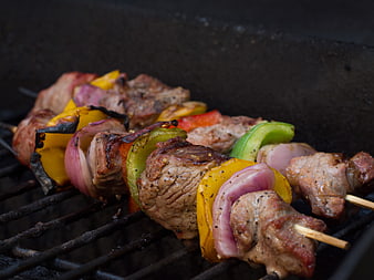 Grilled meat and vegetable skewers on barbecue grill