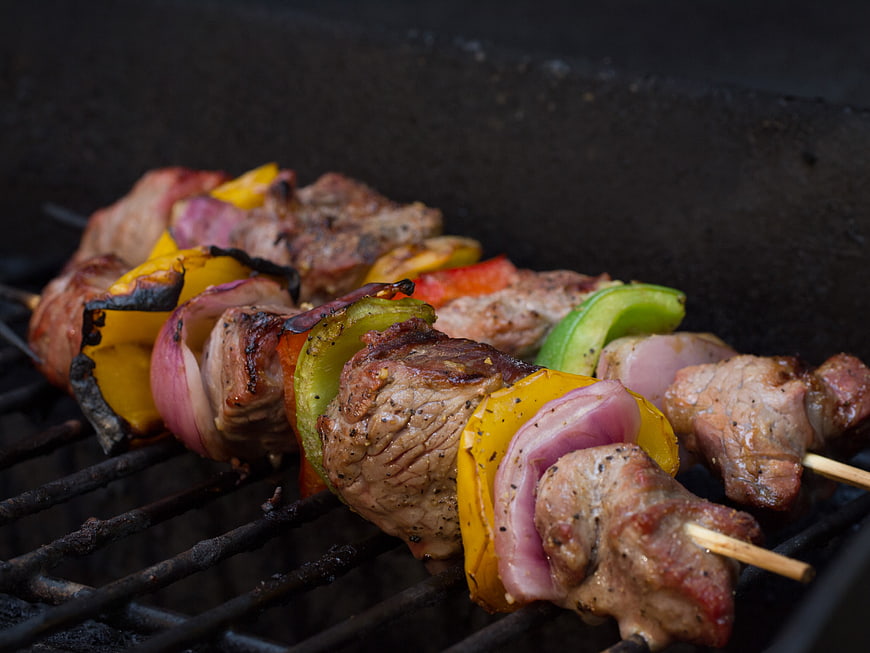Grilled meat and vegetable skewers on barbecue grill