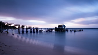 Long Exposure Wooden Pier at Twilight on Calm Ocean