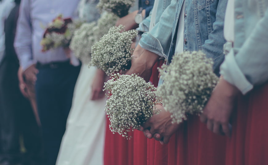 Wedding party holding baby's breath bouquets