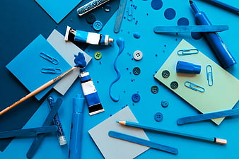 Blue monochrome art supplies flat lay with paint and paper