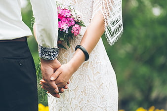 Bride and Groom Holding Hands with Pink Bouquet