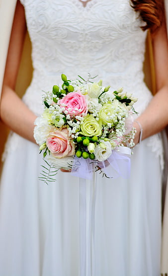 Bride holding pink and white wedding bouquet