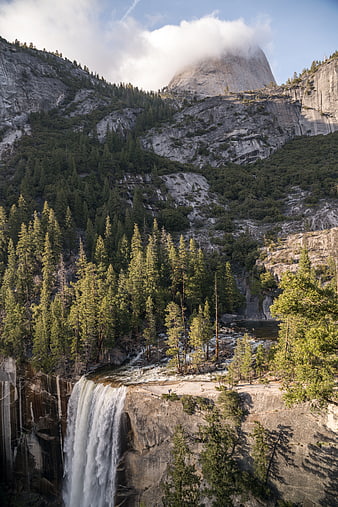 Majestic Yosemite Waterfall with Half Dome in Background