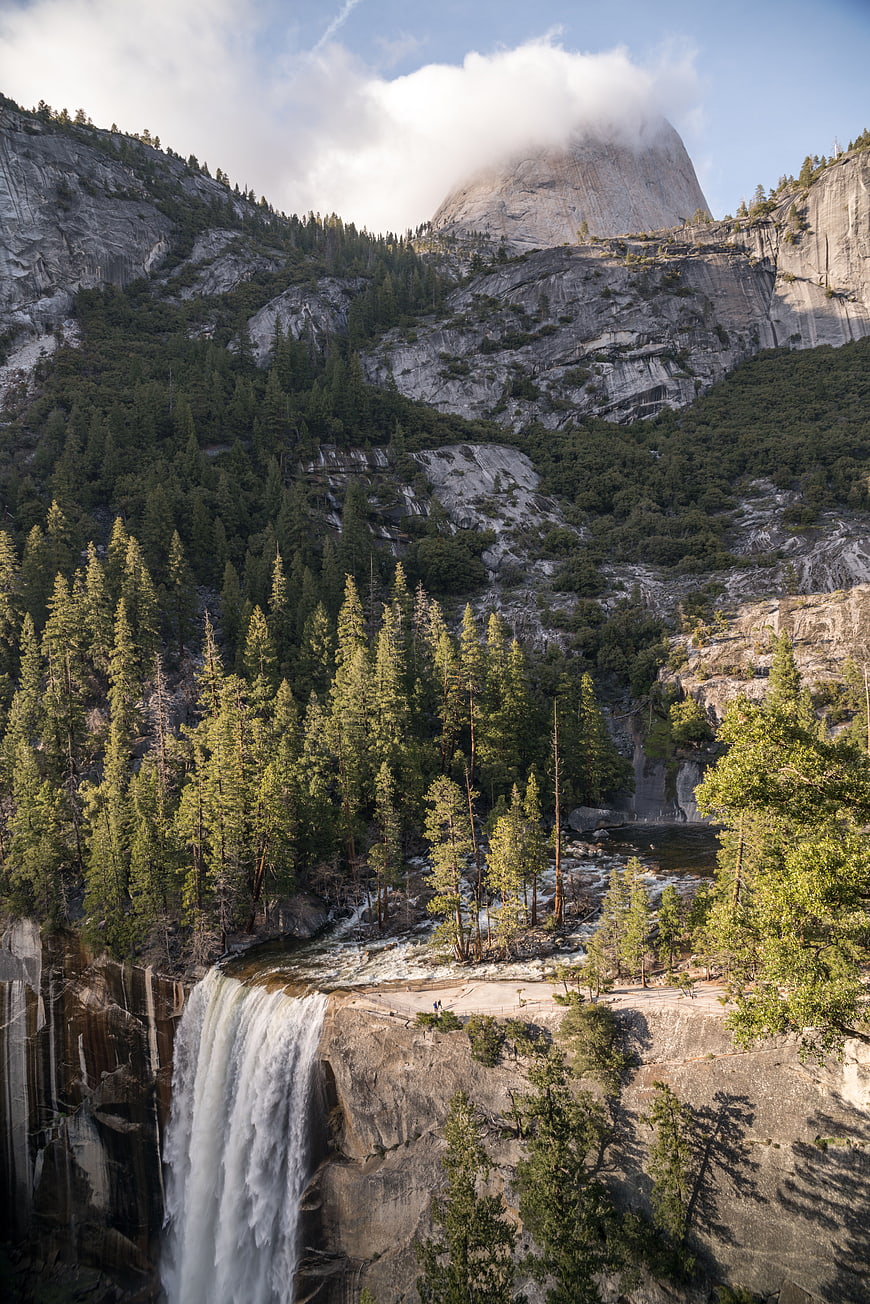 Majestic Yosemite Waterfall with Half Dome in Background