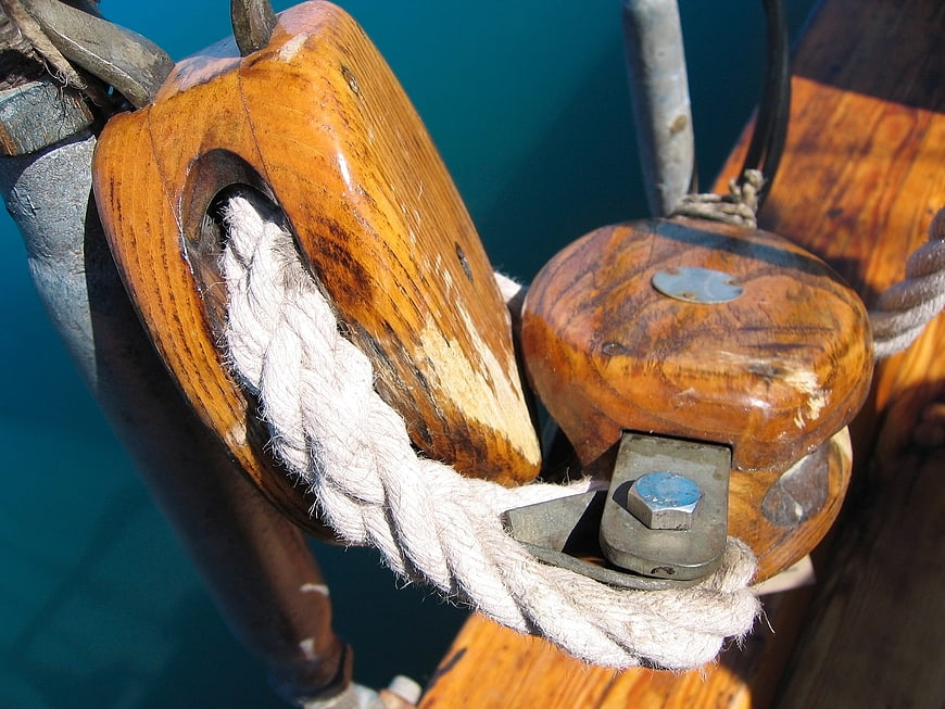 Close-up of vintage wooden ship pulleys and rope