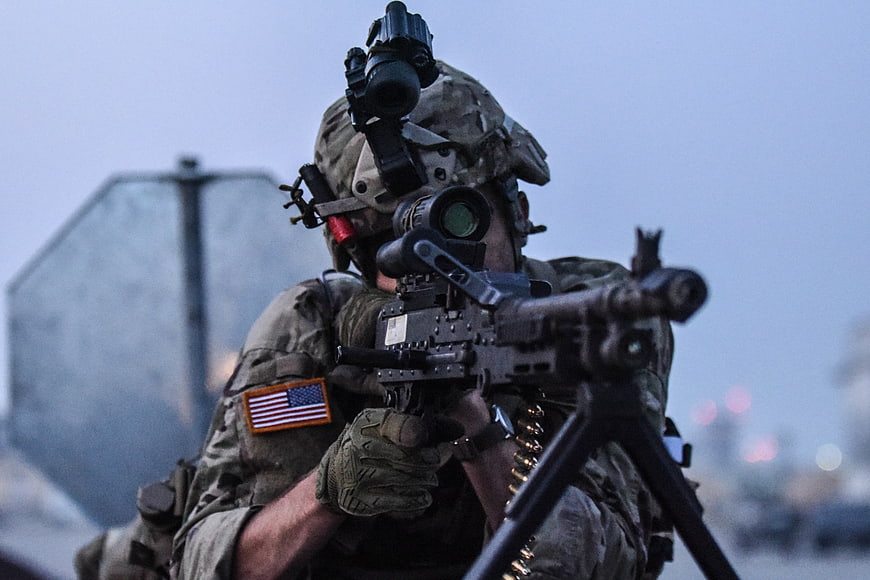 US Army Soldier Aiming Machine Gun at Dusk