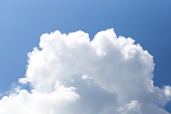 Fluffy White Clouds Against Blue Sky Background