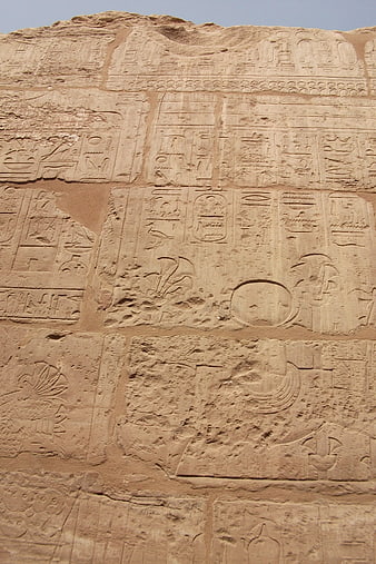 Ancient Egyptian Hieroglyphics Carved on Sandstone Wall