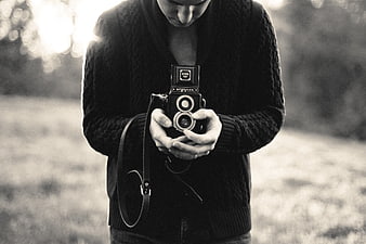 Man Holding Vintage Argoflex Camera in Black and White
