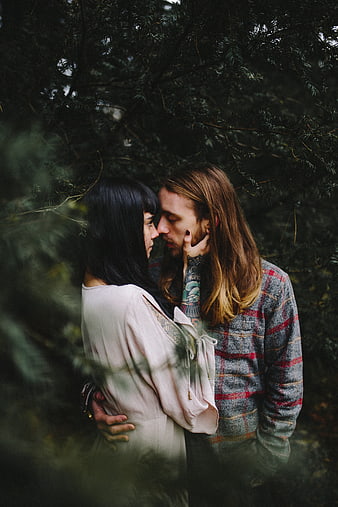 Intimate Couple Embracing in Dark Forest