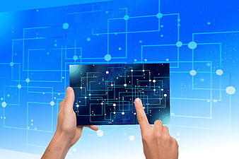 Hands Interacting With Digital Circuit Board On Blue Technology Background