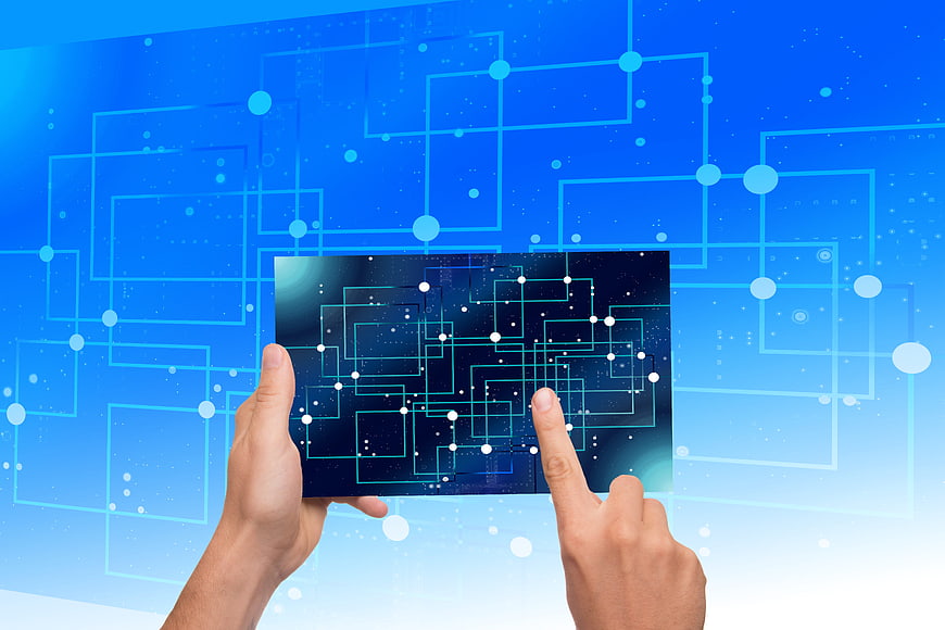Hands Interacting With Digital Circuit Board On Blue Technology Background