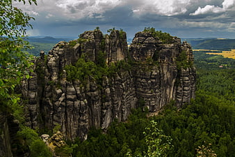 Dramatic Sandstone Rock Formations in Lush Green Forest