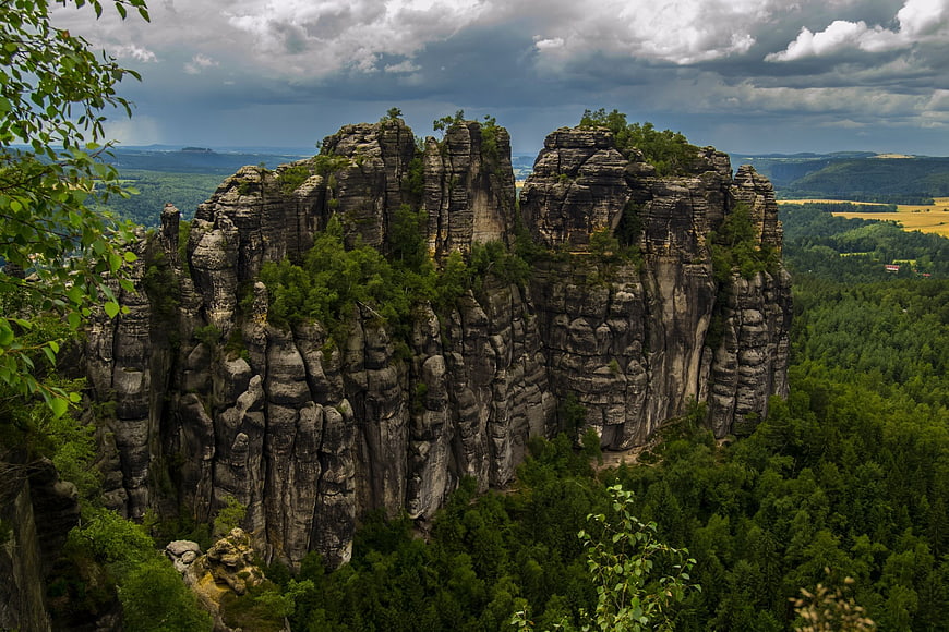 Dramatic Sandstone Rock Formations in Lush Green Forest