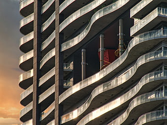 Modern Curved Apartment Building Facade at Sunset