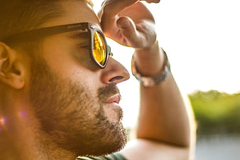 Close-up of man wearing sunglasses in bright sunlight