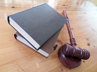 Wooden Gavel and Law Books on Wooden Table