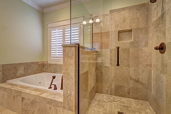 Modern beige bathroom with walk-in shower and soaking tub