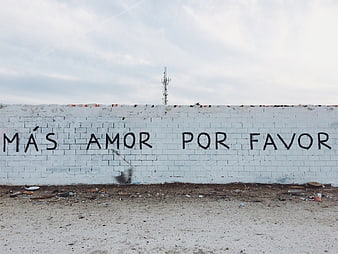 Spanish graffiti wall reading Más amor por favor