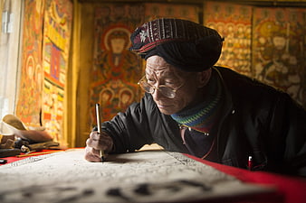 Elderly Asian Artist Painting Traditional Thangka Art