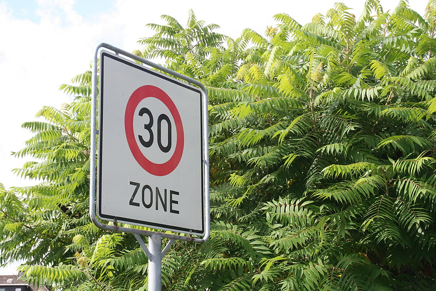 30 Zone Speed Limit Road Sign Against Green Foliage