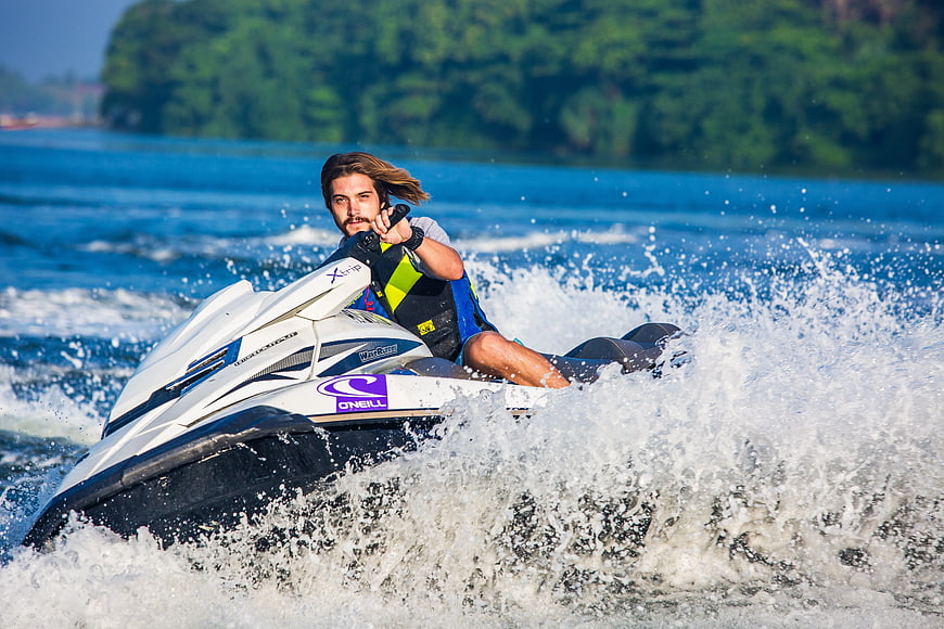 Man riding jet ski on blue ocean water