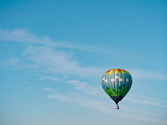 Colorful Hot Air Balloon Flying in Blue Sky