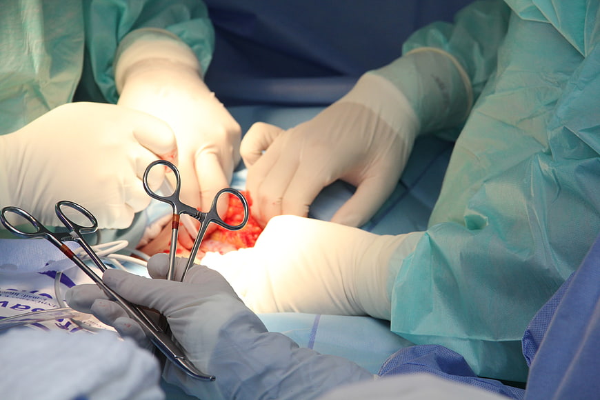 Close-up of surgeons performing surgery with medical instruments