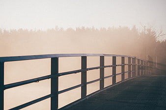 Foggy Bridge with Metal Railing and Silhouette