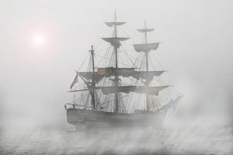 Historic Sailing Ship Emerging From Thick Sea Fog