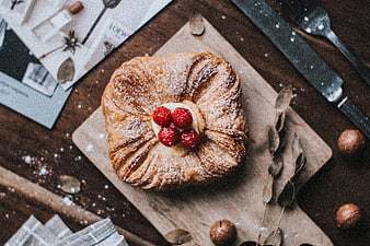Overhead view of sweet raspberry pastry on wooden board