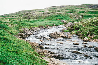 Flowing Mountain Stream Through Green Rocky Valley