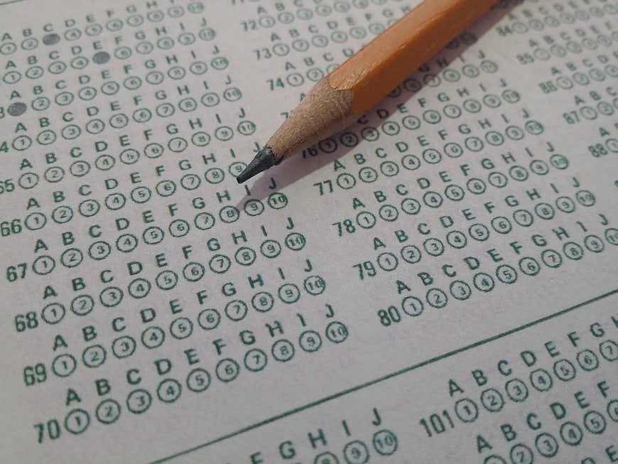 Close-up of orange pencil on standardized test bubble sheet