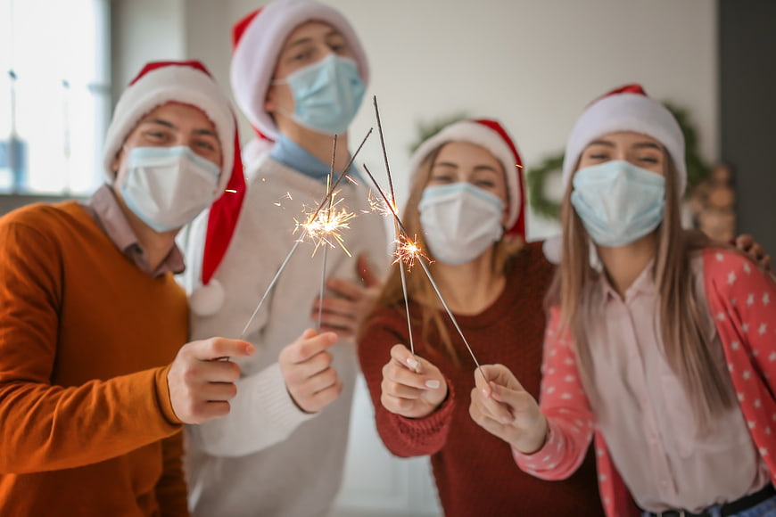 Friends Celebrating Christmas with Sparklers and Face Masks