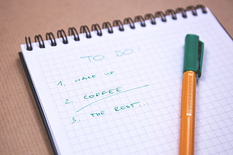 Handwritten to-do list on notebook with pen
