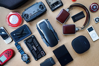 Flat lay of vintage and modern tech gadgets on cork surface