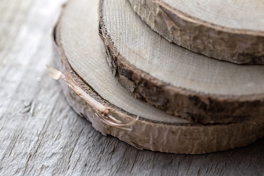 Close-up of rustic wood slices on weathered timber background