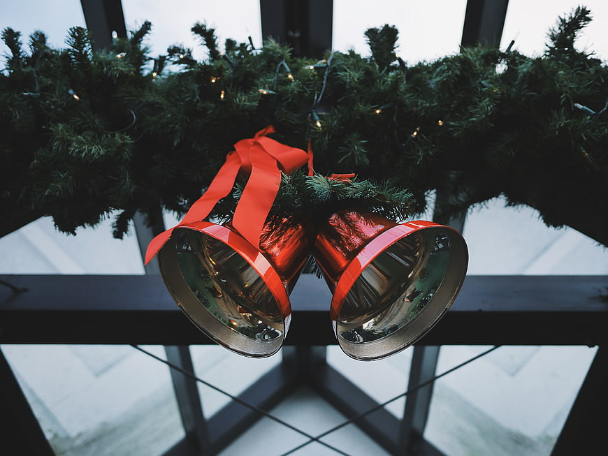 Red Christmas Bells Hanging on Pine Garland