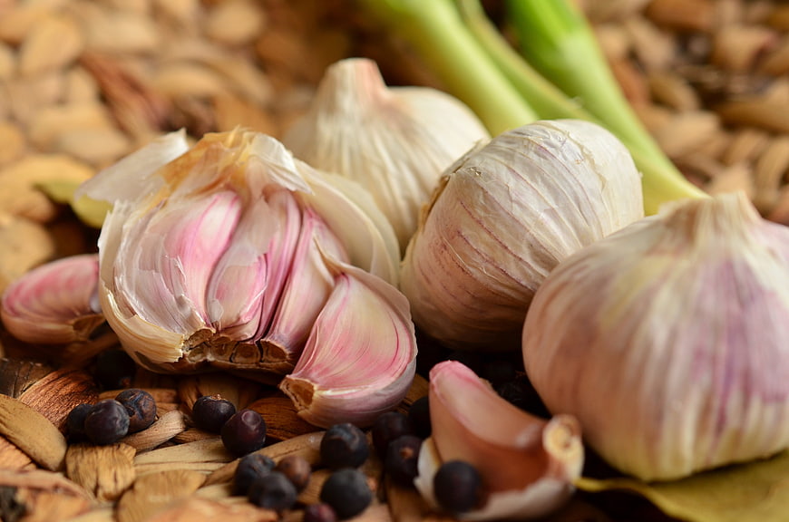 Fresh Garlic Bulbs and Spices on Wooden Surface