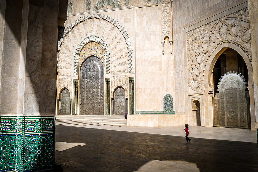Child running in Hassan II Mosque courtyard, Morocco