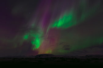 Vibrant Aurora Borealis Over Snowy Arctic Landscape at Night