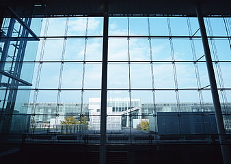 Modern glass office building facade with blue sky