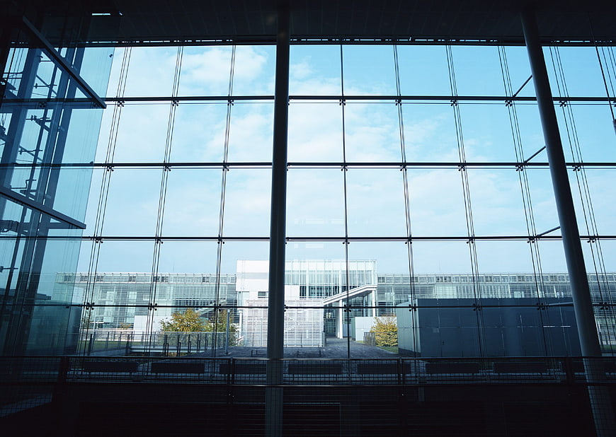 Modern glass office building facade with blue sky