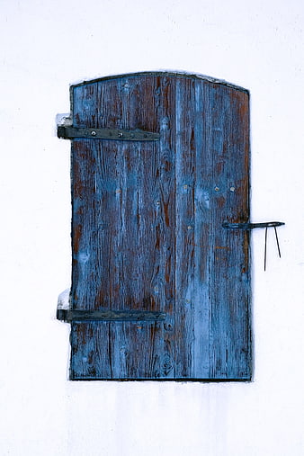 Weathered Blue Wooden Door on White Wall