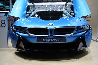 Front view of blue BMW i8 with open butterfly doors