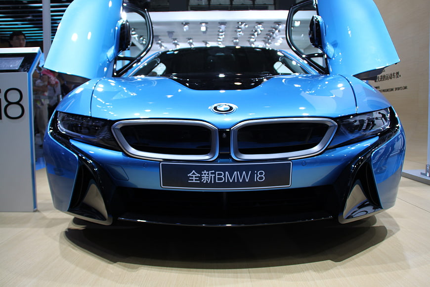 Front view of blue BMW i8 with open butterfly doors