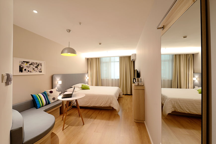 Modern Hotel Bedroom Interior with Sofa and Bed