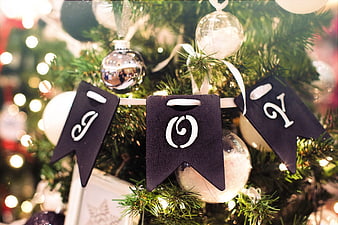 Close-up of JOY Banner on Christmas Tree with Ornaments