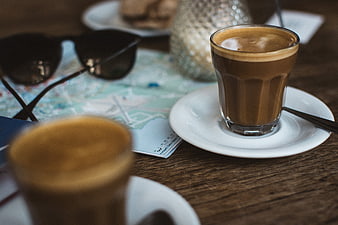 Coffee and travel map on wooden table